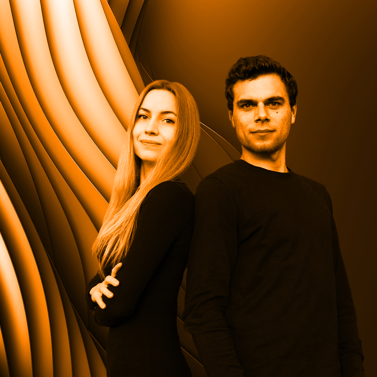 Portrait of a woman and a man standing back-to-back, both wearing black, with an abstract orange and black wavy background.